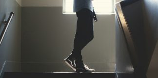 person standing on in a dim-lit stair