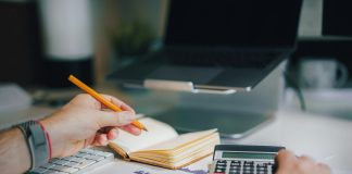 8 din 10 români consideră că impozitarea este excesivă – studiu a person sitting at a desk with a calculator and a notebook