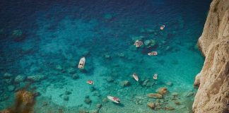 a group of boats floating on top of a body of water