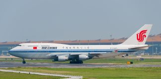 A large jetliner sitting on top of an airport runway