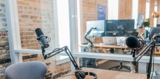 two black headphones on brown wooden table