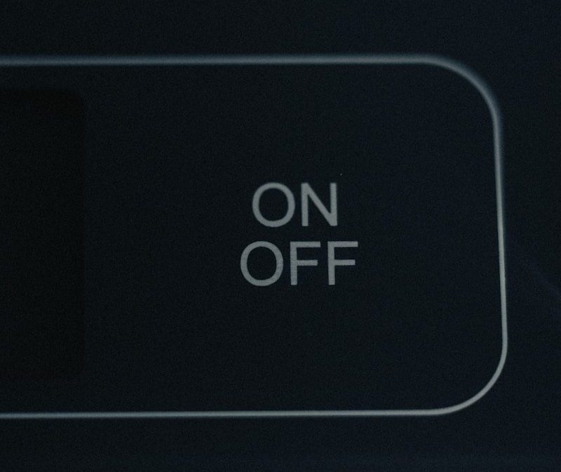 an on off button on a black wall