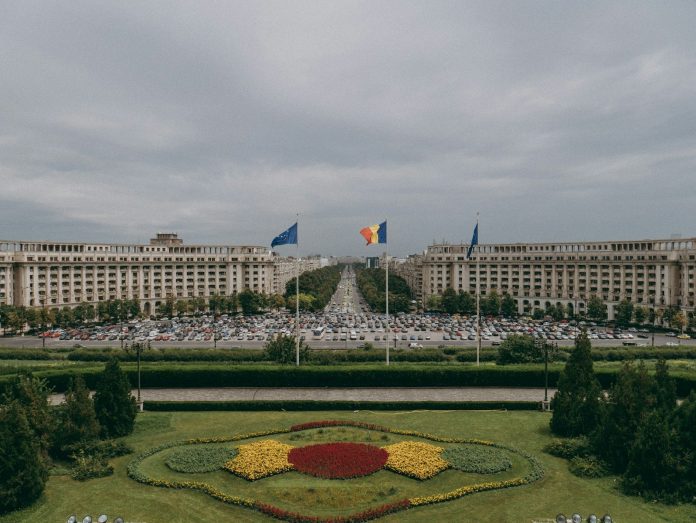 a large flower garden in front of a large building