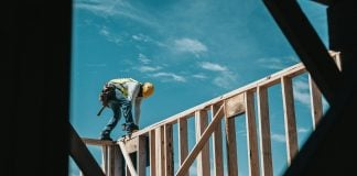 construction worker in hard hat on building frame